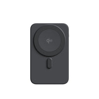 A dark gray MagSafe-compatible wireless charging case or adapter with a circular magnetic ring and a small vertical button, shown on a plain white background.