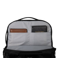 Backpack interior with compartments for items like a wallet and passport on a white background