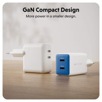 Two Hyper-branded GaN compact wall chargers shown on a wooden surface against a soft light gray background. One charger is plain white, and the other has a blue front face with white text.