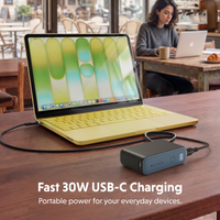 portable power bank on table charging macbook