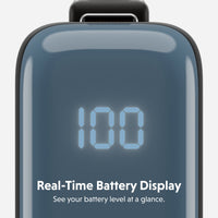 Close-up of a dark slate blue portable battery pack with a glossy finish, featuring a digital LED display showing '100' and the text 'Real-Time Battery Display' and 'See your battery level at a glance.' on a light gray background.