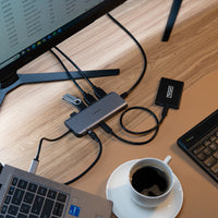 Computer setup with monitor, keyboard, mouse, and coffee on a desk