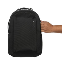 Black backpack held by a hand on a white background