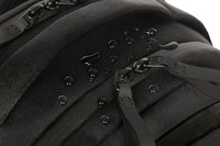 Close-up of a black backpack with zippers and straps on a white background