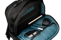 Black backpack with blue interior containing a laptop, mouse, and other items on a white background