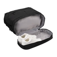 A black shoe bag shown open, with a pair of white sneakers inside, on a plain white background.