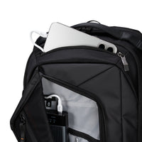 Black backpack with electronic devices inside on a white background