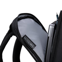 Black sling bag with a laptop and cable, featuring 'Sling Backpack' brand label.