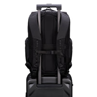 Black backpack with trolley strap on a suitcase on a white background