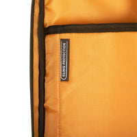 Close-up of orange fabric with a 'Sling Protection' label on a white background