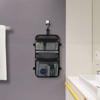 Targus black laptop backpack inside accessory compartment lifestyle on bathroom wall