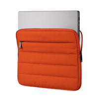 Orange laptop sleeve with a silver laptop inside on a white background