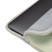 Green zippered pouch with a black electronic device inside on a white background