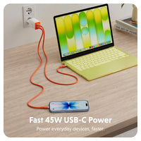 An orange USB-C power cable shown plugging into a wall outlet and connecting to a laptop and smartphone on a wooden desk. The text at the bottom reads 'Fast 45W USB-C Power Power everyday devices, faster.