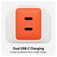 An orange dual USB-C charging adapter with two USB-C ports, shown on a light gray background with text below reading 'Dual USB-C Charging' and 'Charge two devices from a single charger.'.