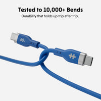 Blue USB-C charging cable with metallic silver connector ends, shown on a light gray background with text reading 'Tested to 10,000+ Bends' and 'Durability that holds up trip after trip.'.