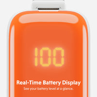 Close-up of an orange portable battery pack with a digital LED display showing 100 and the text 'Real-Time Battery Display' and 'See your battery level at a glance.' on a light gray background.